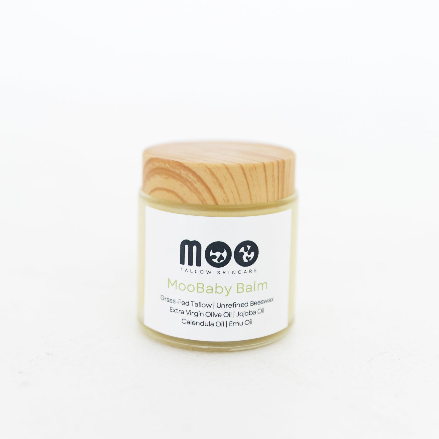 Jar of Moobaby balm with wooden lid on a white background